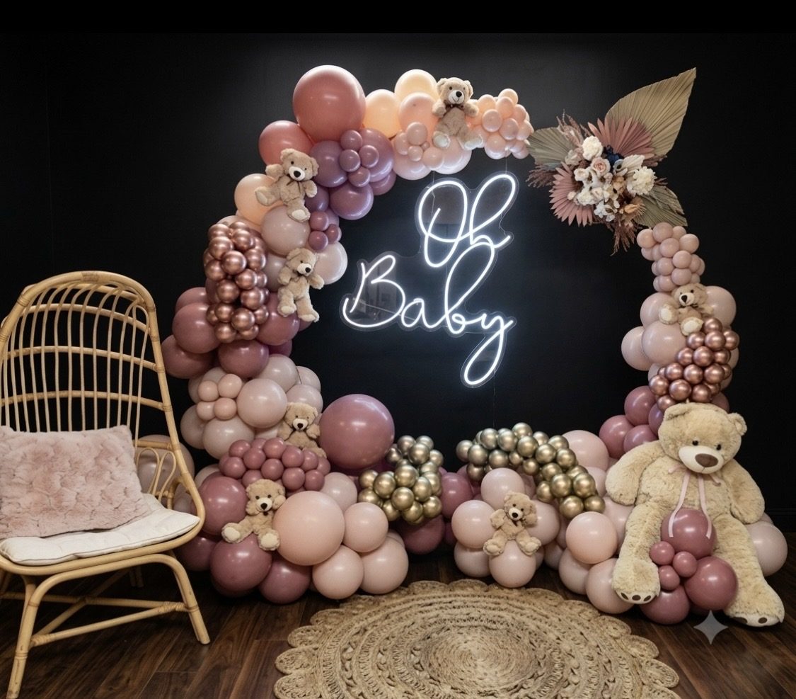 Mauve and nude balloon garland framing an 'Oh Baby' neon sign