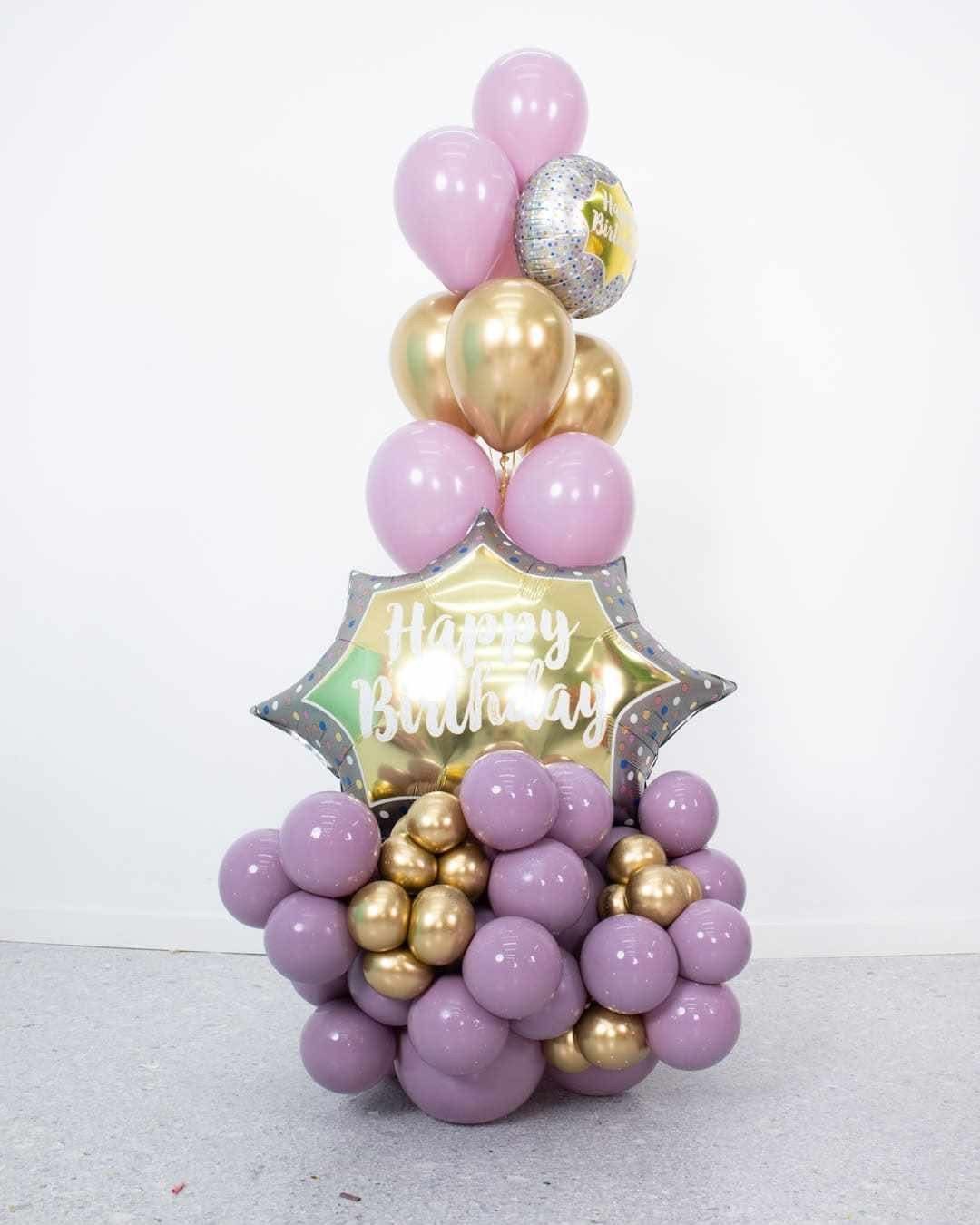 Pastel balloon column with star foil balloons for a birthday