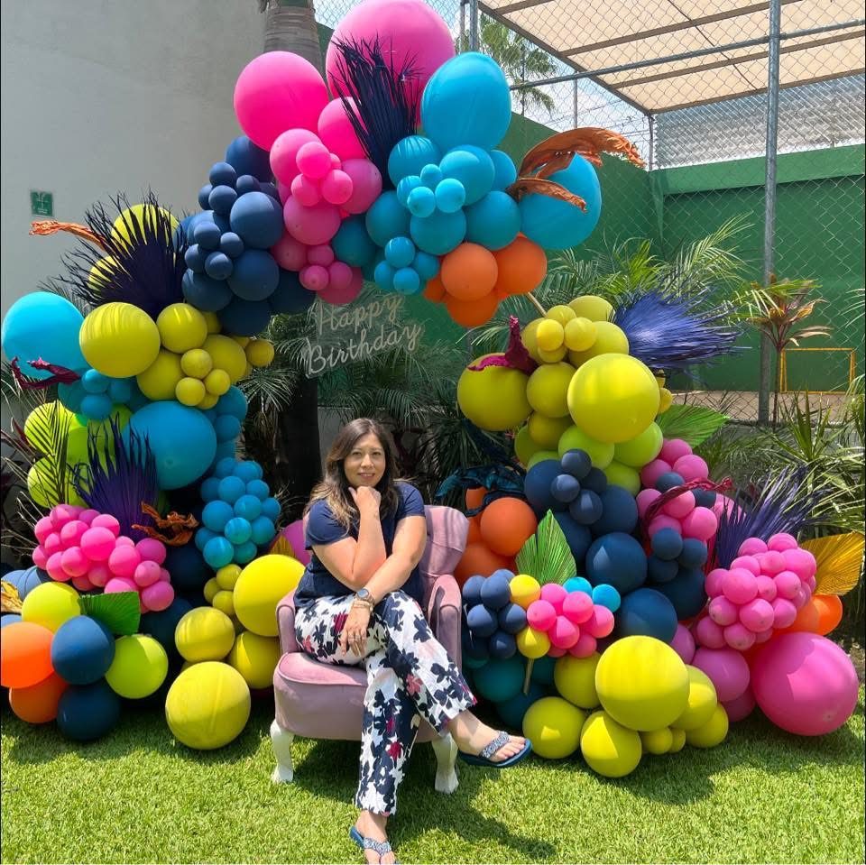 Colorful tropical balloon garland with lounge seating outdoors