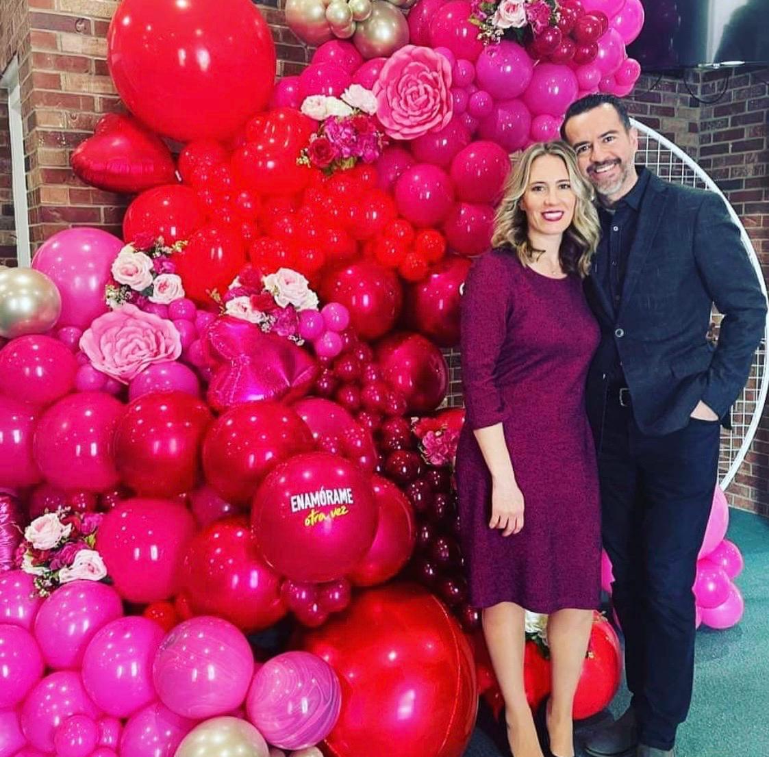 Bright pink floral balloon wall for an anniversary celebration