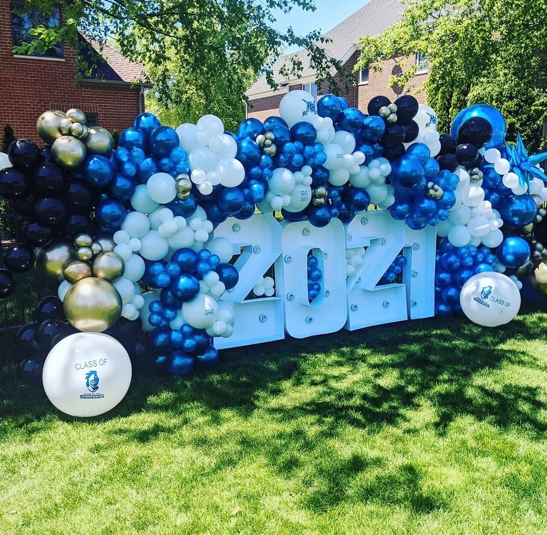 Blue and white outdoor graduation balloon installation