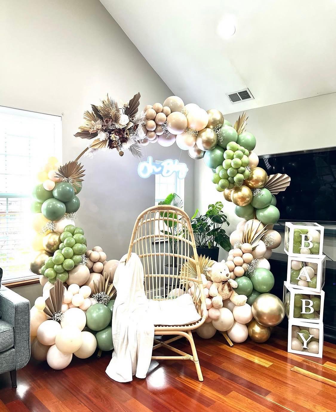 Organic pastel balloon arch with a woven statement chair