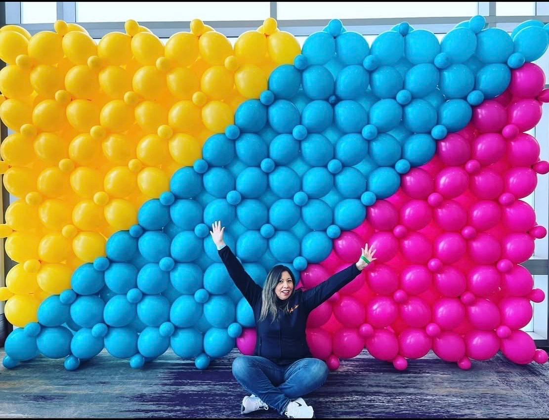 Bold yellow, blue and pink balloon wall